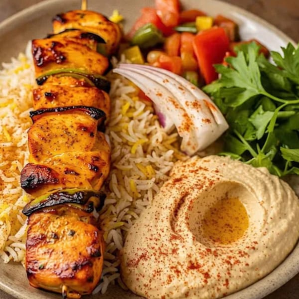 Gyro King Grill's chicken shish tawook with rice, hummus, salad, and red onion.