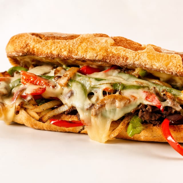 Cheese Steak, French Fries and Can Soda.